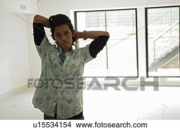 Stock Photo - young man standing 
in room, portrait. 
fotosearch - search 
stock photos, 
pictures, images, 
and photo clipart