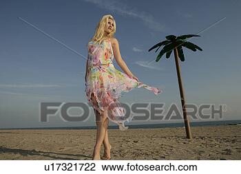 Stock Photo - blond woman posing 
in sand. fotosearch 
- search stock 
photos, pictures, 
images, and photo 
clipart