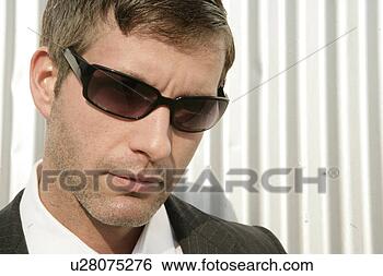 Stock Photo - buinessman looking 
at camera wearing 
shades. fotosearch 
- search stock 
photos, pictures, 
images, and photo 
clipart