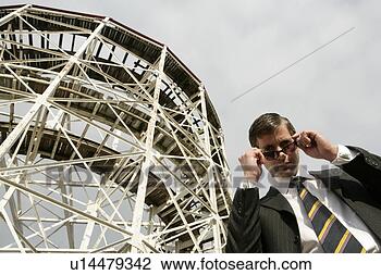 Stock Photo - business man looking 
over shades. fotosearch 
- search stock 
photos, pictures, 
images, and photo 
clipart