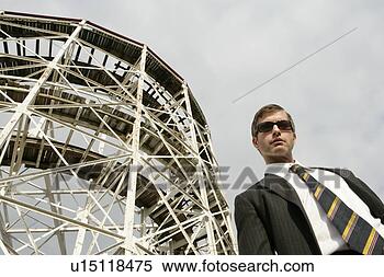 Stock Image - business man standing 
beside a large 
metal structure. 
fotosearch - search 
stock photos, 
pictures, images, 
and photo clipart