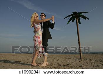 Stock Photography - caucasian couple 
dancing bare foot 
in the sand. fotosearch 
- search stock 
photos, pictures, 
images, and photo 
clipart