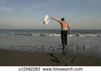 Stock Photo - man tossing off 
his shirt. fotosearch 
- search stock 
photos, pictures, 
images, and photo 
clipart