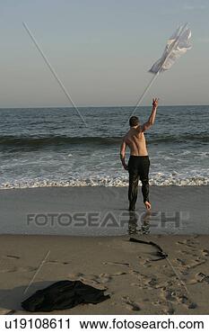 Stock Photography - man tossing off 
his clothes. fotosearch 
- search stock 
photos, pictures, 
images, and photo 
clipart