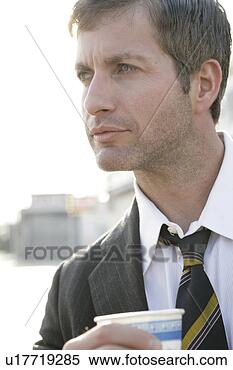 Stock Image - man wearing a 
tie holding a 
take out cup. 
fotosearch - search 
stock photos, 
pictures, images, 
and photo clipart