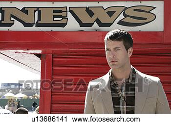Stock Photography - caucasian man 
standing near 
a news sign. fotosearch 
- search stock 
photos, pictures, 
images, and photo 
clipart