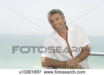 Picture - mature married 
man smiling on 
a terrace. fotosearch 
- search stock 
photos, pictures, 
images, and photo 
clipart