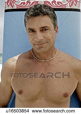 Stock Photo - view of a man 
holding a surfboard. 
fotosearch - search 
stock photos, 
pictures, images, 
and photo clipart