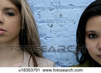 Stock Photography - view of two women 
near a wall. fotosearch 
- search stock 
photos, pictures, 
images, and photo 
clipart