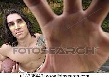 Stock Photograph - view of a young 
man holding a 
rugby ball. fotosearch 
- search stock 
photos, pictures, 
images, and photo 
clipart