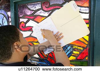Stock Photography - boy (11-13) writing 
on book, close-up. 
fotosearch - search 
stock photos, 
pictures, images, 
and photo clipart
