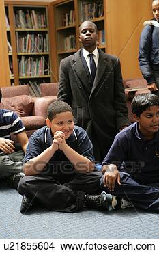 Stock Photo - boys (11-13) sitting 
in library, looking 
away. fotosearch 
- search stock 
photos, pictures, 
images, and photo 
clipart