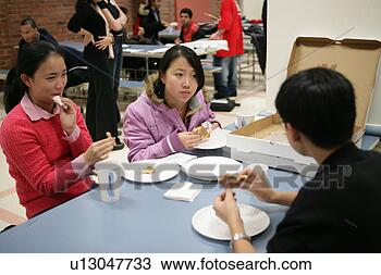 Stock Photo - girls (16-17) 
with boy (16-17) 
eating pizza in 
canteen. fotosearch 
- search stock 
photos, pictures, 
images, and photo 
clipart
