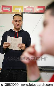 Stock Photograph - teenage boy (15-17) 
holding paper. 
fotosearch - search 
stock photos, 
pictures, images, 
and photo clipart