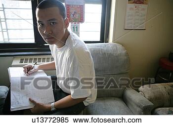 Stock Image - teenage boy (15-17) 
sitting with book, 
portrait. fotosearch 
- search stock 
photos, pictures, 
images, and photo 
clipart