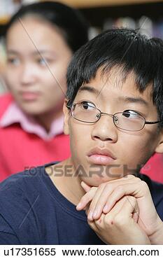 Stock Image - teenage boy (15-17) 
in contemplative 
mood, close-up. 
fotosearch - search 
stock photos, 
pictures, images, 
and photo clipart