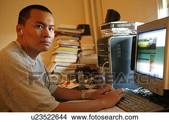 Stock Photo - teenage boy (15-17) 
operating computer. 
fotosearch - search 
stock photos, 
pictures, images, 
and photo clipart