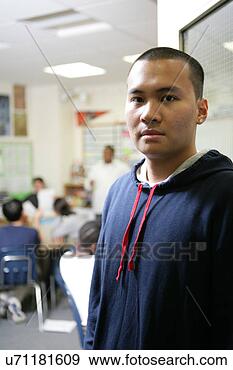 Stock Photograph - teenage boy (15-17) 
standing in classroom, 
portrait. fotosearch 
- search stock 
photos, pictures, 
images, and photo 
clipart