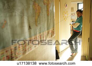 Stock Photo - teenage girl (15-17) 
leaning on doorframe. 
fotosearch - search 
stock photos, 
pictures, images, 
and photo clipart