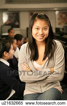 Stock Image - teenage girl (15-17) 
sitting in classroom, 
portrait. fotosearch 
- search stock 
photos, pictures, 
images, and photo 
clipart