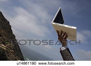 Stock Photography - view of a laptop 
held by a person. 
fotosearch - search 
stock photos, 
pictures, images, 
and photo clipart