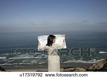 Stock Photo - view of a woman 
reading a map. 
fotosearch - search 
stock photos, 
pictures, images, 
and photo clipart
