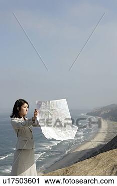 Stock Photography - view of a woman 
reading a map. 
fotosearch - search 
stock photos, 
pictures, images, 
and photo clipart