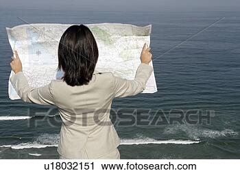 Stock Photography - view of a woman 
reading a map. 
fotosearch - search 
stock photos, 
pictures, images, 
and photo clipart