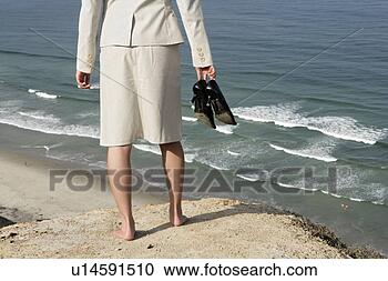 Stock Photography - view of a woman 
standing on a 
cliff. fotosearch 
- search stock 
photos, pictures, 
images, and photo 
clipart