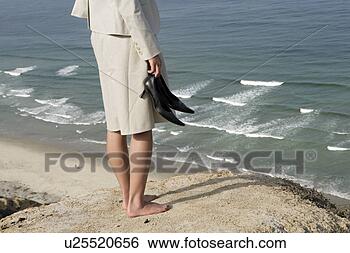 Stock Photo - view of a woman 
standing on a 
cliff. fotosearch 
- search stock 
photos, pictures, 
images, and photo 
clipart