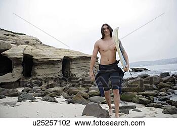 Stock Photo - view of a man 
holding a surfboard. 
fotosearch - search 
stock photos, 
pictures, images, 
and photo clipart