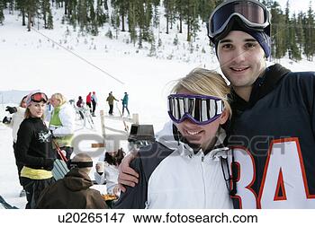 Picture - couple on ski 
slope looking 
at camera. fotosearch 
- search stock 
photos, pictures, 
images, and photo 
clipart