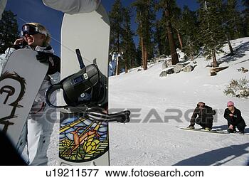 Picture - woman on cellphone, 
couple in backgroud 
on a ski slope. 
fotosearch - search 
stock photos, 
pictures, images, 
and photo clipart