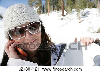Stock Photography - woman on ski slope 
on her cellphone. 
fotosearch - search 
stock photos, 
pictures, images, 
and photo clipart