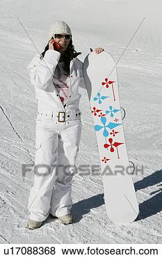 Stock Photo - woman with snowboard 
talking on a cell 
phone. fotosearch 
- search stock 
photos, pictures, 
images, and photo 
clipart