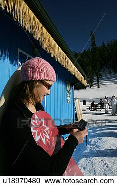 Stock Photography - woman with snowboard 
texting. fotosearch 
- search stock 
photos, pictures, 
images, and photo 
clipart