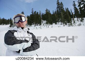 Stock Photo - woman standing 
on ski slope with 
her arms folded. 
fotosearch - search 
stock photos, 
pictures, images, 
and photo clipart