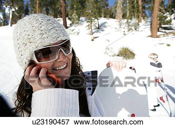 Picture - woman talking 
on cell phone 
on a ski slope. 
fotosearch - search 
stock photos, 
pictures, images, 
and photo clipart
