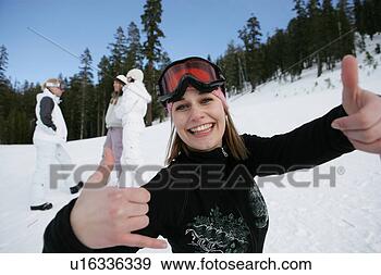Stock Photograph - women looking 
at camera with 
a thumbs up gesture. 
fotosearch - search 
stock photos, 
pictures, images, 
and photo clipart