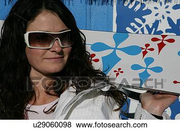 Stock Photo - young woman holding 
a snow board. 
fotosearch - search 
stock photos, 
pictures, images, 
and photo clipart