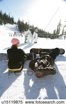 Stock Image - couple sitting 
on a ski slope. 
fotosearch - search 
stock photos, 
pictures, images, 
and photo clipart