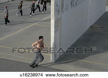 Stock Photo - man running beside 
a handball court. 
fotosearch - search 
stock photos, 
pictures, images, 
and photo clipart