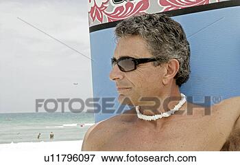 Picture - view of a man 
with a surfboard. 
fotosearch - search 
stock photos, 
pictures, images, 
and photo clipart