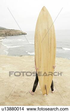 Stock Photo - view of a person 
hidden with a 
surfboard. fotosearch 
- search stock 
photos, pictures, 
images, and photo 
clipart
