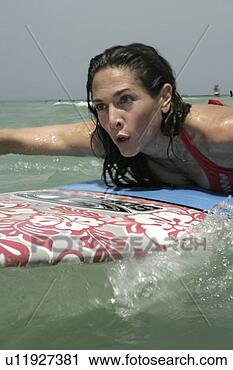 Stock Photography - view of a woman 
surfboarding. 
fotosearch - search 
stock photos, 
pictures, images, 
and photo clipart