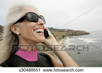 Stock Photography - view of a woman 
talking on a cellphone. 
fotosearch - search 
stock photos, 
pictures, images, 
and photo clipart