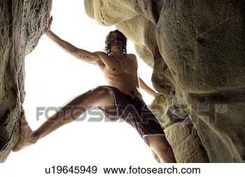 Stock Photograph - view of a young 
man rock climbing. 
fotosearch - search 
stock photos, 
pictures, images, 
and photo clipart