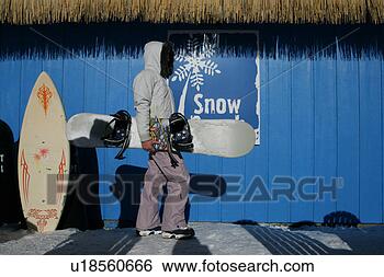 Stock Photo - woman standing 
sideways holding 
a snowboard. fotosearch 
- search stock 
photos, pictures, 
images, and photo 
clipart