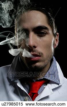 Stock Image - close-up of young 
man with smoke 
coming out of 
his mouth. fotosearch 
- search stock 
photos, pictures, 
images, and photo 
clipart