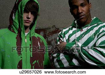 Stock Photo - two young men 
standing side 
by side. fotosearch 
- search stock 
photos, pictures, 
images, and photo 
clipart